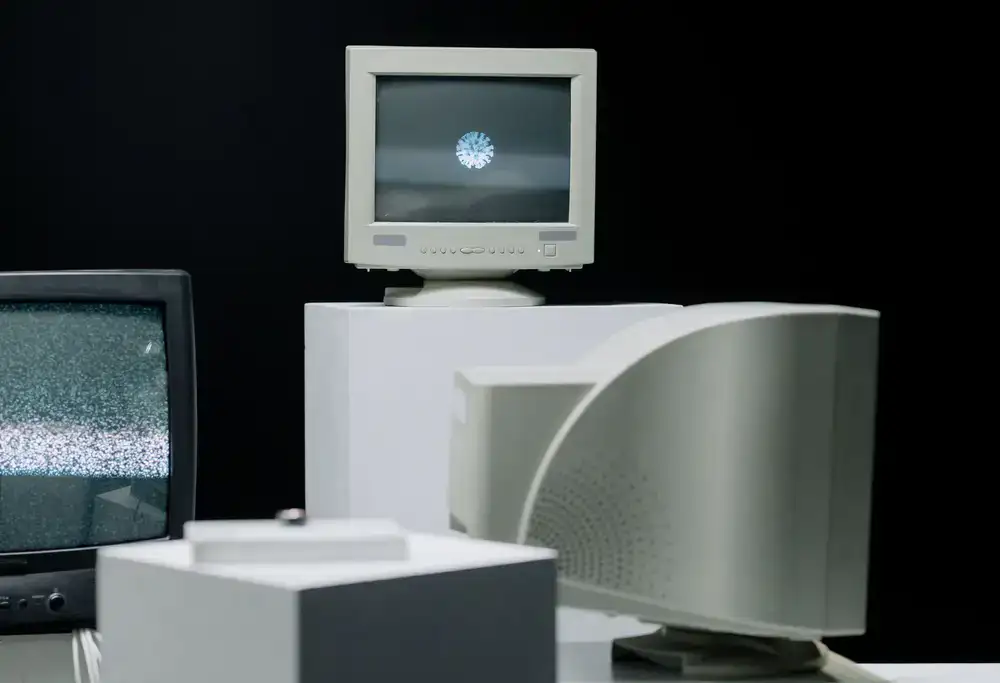 Glowing CRT screens displaying vintage trade interfaces